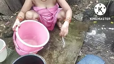 Indian house wife bathing outside