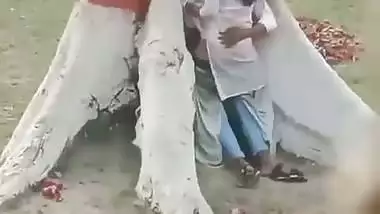 College couple enjoys outdoor sex below a big tree