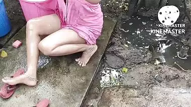 Indian house wife bathing outside