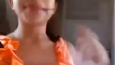 Indian babe in orange takes clothes off to flaunt boobs and buttocks