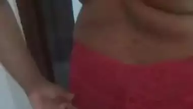 Desi woman puts on clothes in front of cameraman filming porn video
