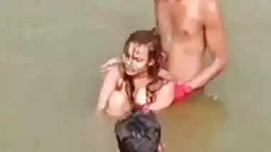 Village girl nude in river, naked boobs pressed by friends