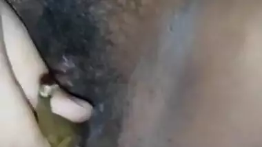 Indian Bhabhi Arpita fingering her hairy pussy with Brinjal
